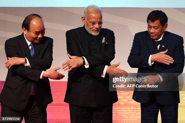 Vietnam's Prime Minister Nguyen Xuan Phuc , India's Prime Minister Narendra Modi and Philippine President Rodrigo Duterte shake hands for a family...