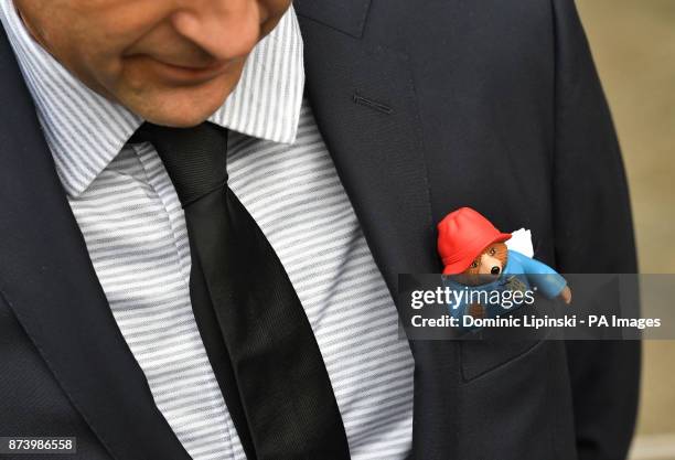 Man arriving for a memorial service for Paddington author Michael Bond at St Paul&acirc;s Cathedral, London, with a Paddington Bear in his suit...