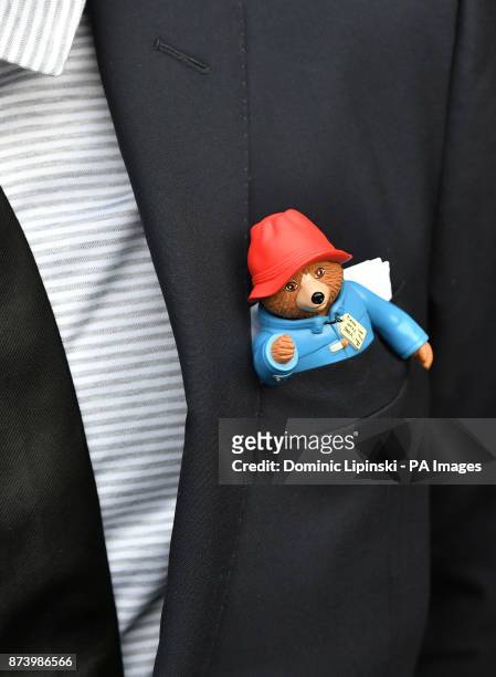 Man arriving for a memorial service for Paddington author Michael Bond at St Paul&acirc;s Cathedral, London, with a Paddington Bear in his suit...