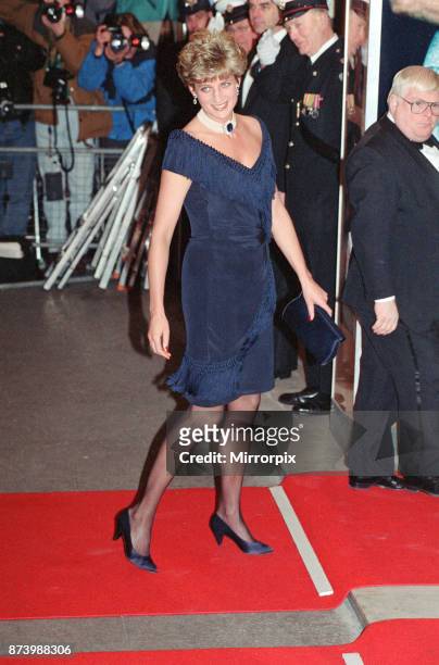 Princess Diana, Princess of Wales, arrives for the premiere of The Prince of Tides at Odeon Leicester Square, London in a stunning sapphire blue...