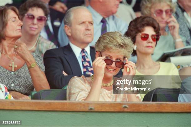 Princess Diana, Princess of Wales, attends the 1993 Men's Singles Wimbledon Tennis Final. She wears or attends to her sunglasses for most of the...