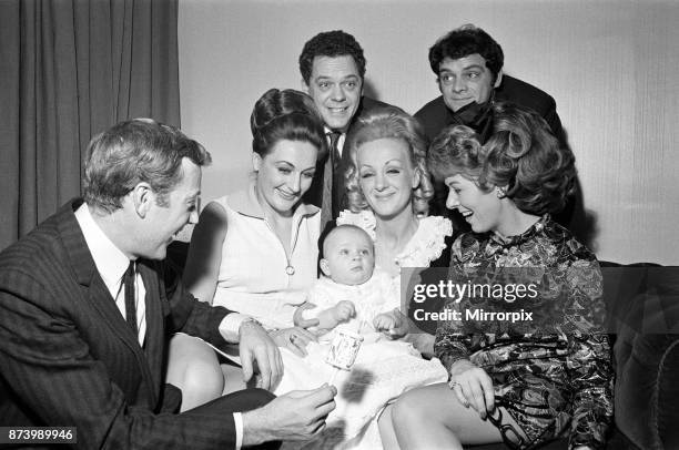 Val Doonican and his wife Lynn in supporting roles at the christening of baby Russell Beamont White. The baby is the son of actor Arthur White who...