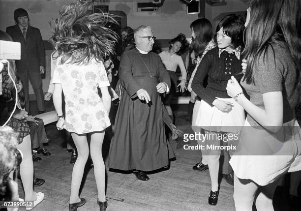 The Bishop of Durham, Dr. Ian Ramsey, dancing with fifteen-year-old Isobel Brennan from Jarrow, at the 'Change Is' discotheque in Newcastle upon...