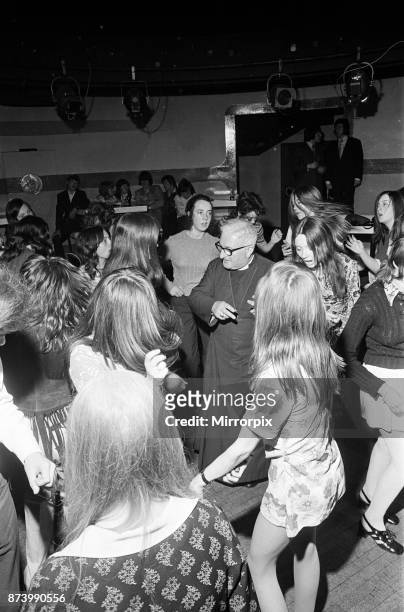 The Bishop of Durham, Dr. Ian Ramsey, dancing with fifteen-year-old Isobel Brennan from Jarrow, at the 'Change Is' discotheque in Newcastle upon...