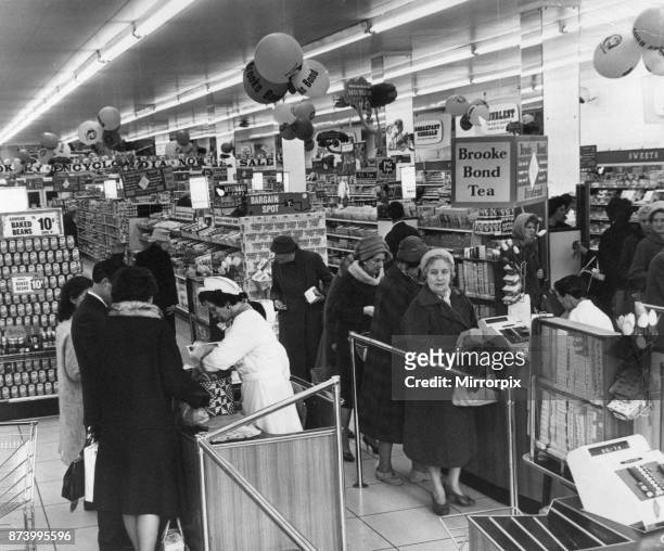 Shoppers pay for their goods at a supermarket in Cardiff, Wales, 16th May 1963.