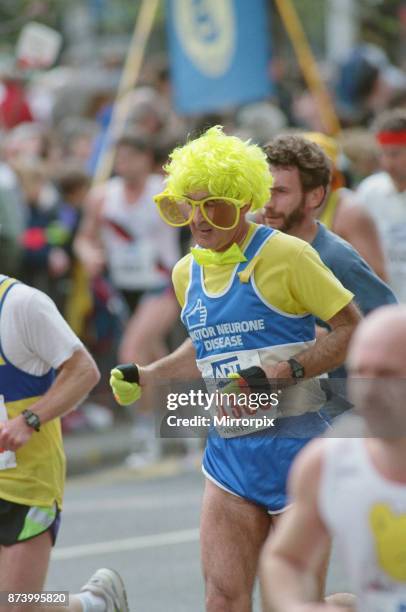 The London Marathon, 1991. Runners passing through and around Tower Bridge. A runner in Fancy Dress, running for The Motor Neurone Disease Charity...