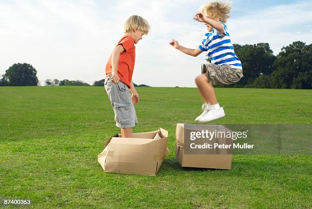 boys jumping on boxes - breaker box stockfoto's en -beelden