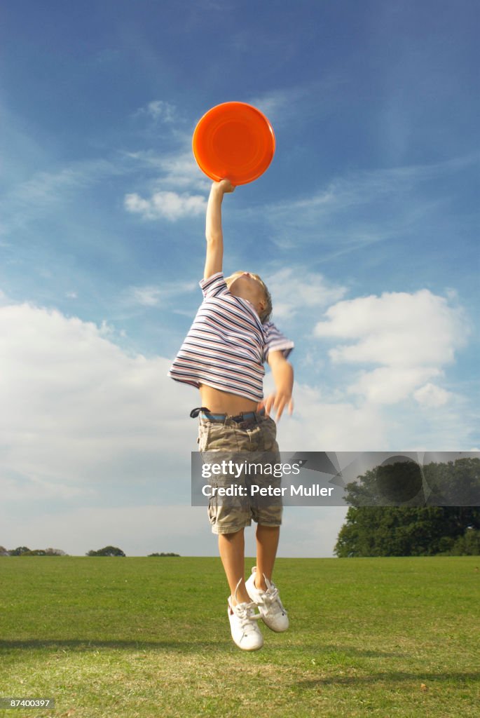 Boy catching frisbee