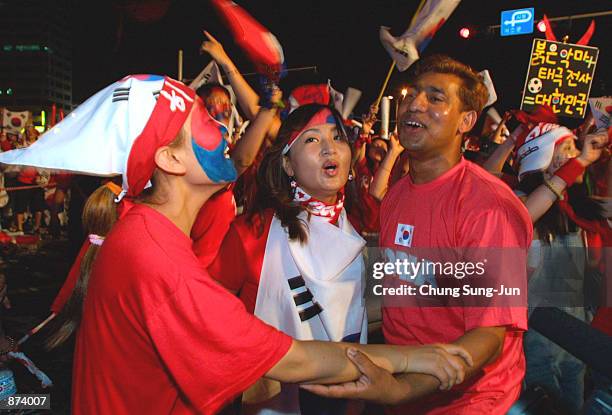 South Korean soccer fans celebrate despite watching their team lose the 2002 Federation Internationale de Football Association Korea-Turkey World Cup...