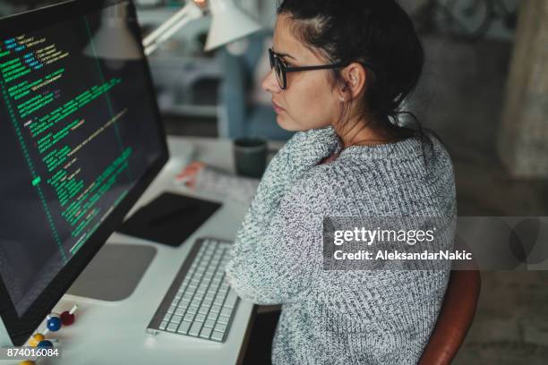 young woman programming at her home office - developers coding stock pictures, royalty-free photos & images