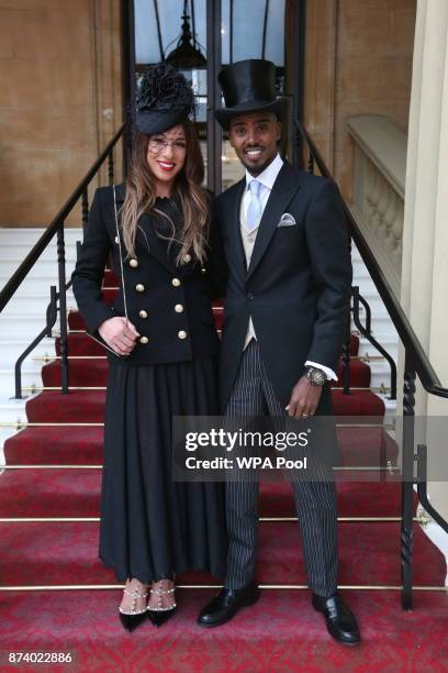 Four-time Olympic champion Sir Mo Farah and his wife Tania pose, prior to him receiving his knighthood from Queen Elizabeth II at Buckingham Palace...