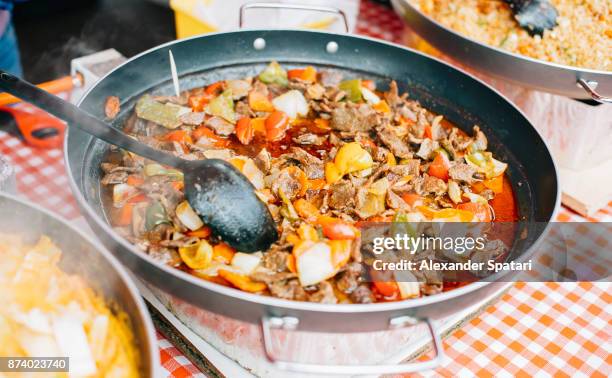 beef cooked in a big frying pan, portobello market, london, uk - food festival stock pictures, royalty-free photos & images