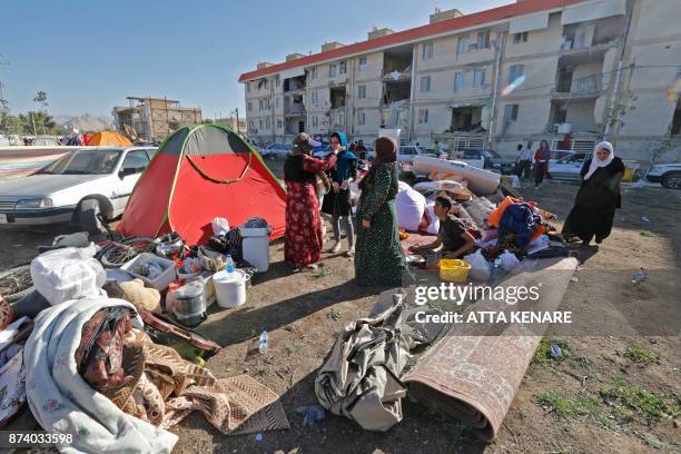 Iranians camp in tents and make-shift shelters outside near damaged buildings in the town of Sarpol-e Zahab in the western Kermanshah province near...