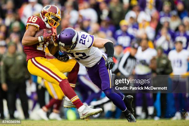 Free safety Harrison Smith of the Minnesota Vikings tackles wide receiver Josh Doctson of the Washington Redskins in the fourth quarter at FedExField...