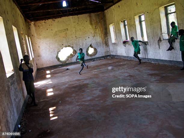 Children seen playing in a damaged classroom in a local school. During the war soldiers took the local school and changed it to the military...