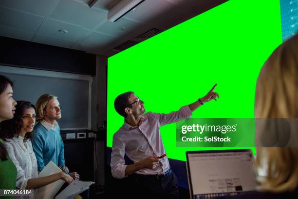 adults viewing a large display green screen - identification chart stock pictures, royalty-free photos & images