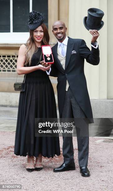 Four-time Olympic champion Sir Mo Farah and his wife Tania pose, prior to him receiving his knighthood from Queen Elizabeth II at Buckingham Palace...