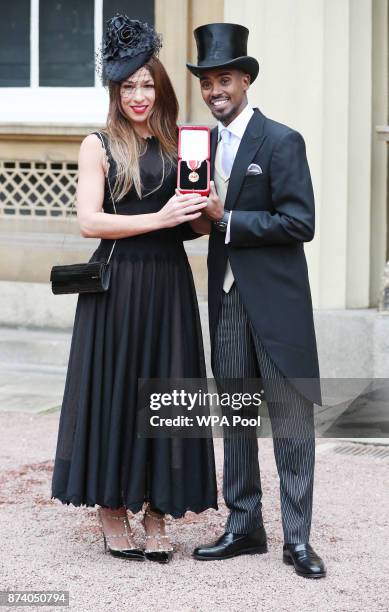 Four-time Olympic champion Sir Mo Farah and his wife Tania pose, prior to him receiving his knighthood from Queen Elizabeth II at Buckingham Palace...