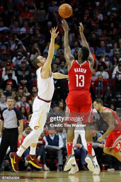 James Harden of the Houston Rockets takes a three point shot defended by Kevin Love of the Cleveland Cavaliers in the second half at Toyota Center on...