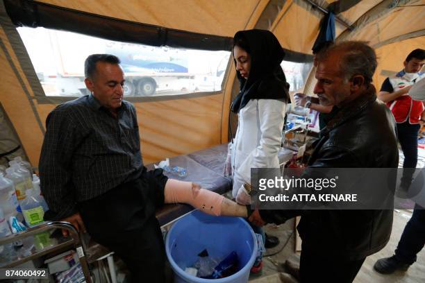 Iranian medics tend to quake victims and survivors at a field hospital in the town of Sarpol-e Zahab in the western Kermanshah province near the...