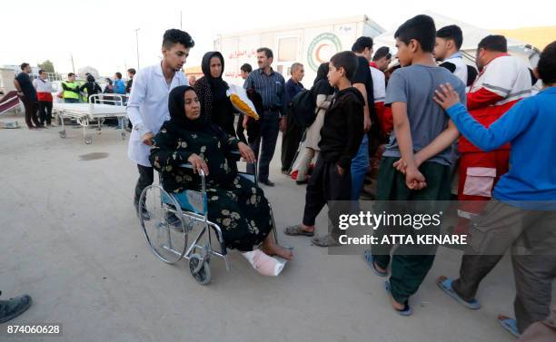 Iranian quake victims and survivors arrive to receive treatment at a field hospital in the town of Sarpol-e Zahab in the western Kermanshah province...