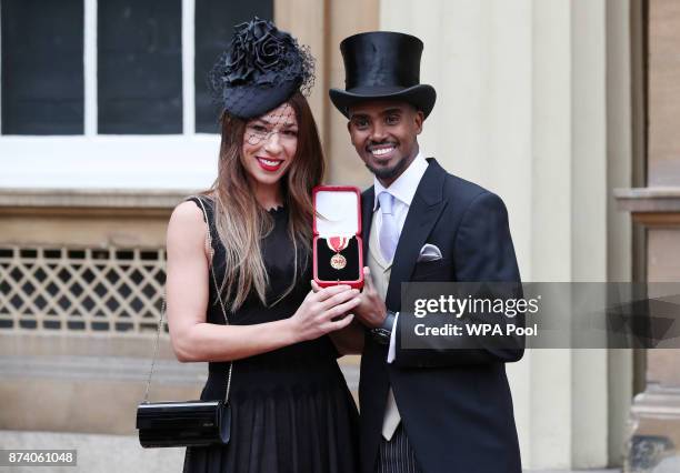 Four-time Olympic champion Sir Mo Farah and his wife Tania pose, prior to him receiving his knighthood from Queen Elizabeth II at Buckingham Palace...