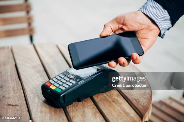 contactless payment with smart phone - contactless stock pictures, royalty-free photos & images