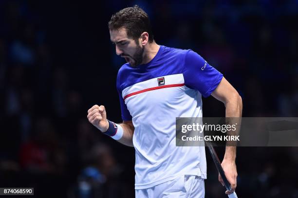 Croatia's Marin Cilic reacts after winning a point against USA's Jack Sock during their men's singles round-robin match on day three of the ATP World...