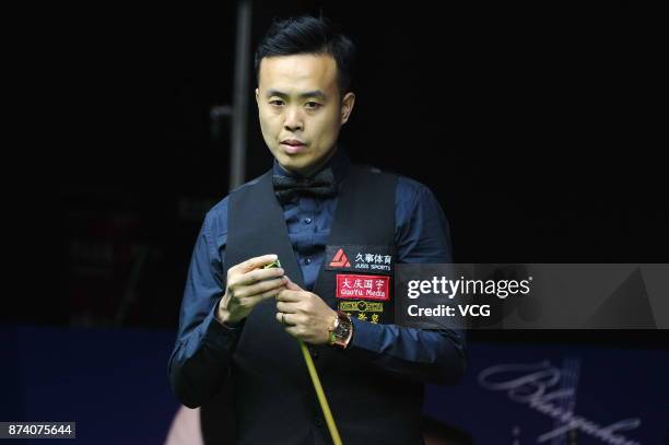 Marco Fu of Chinese Hong Kong chalks the cue during the first round match against Hossein Vafaei of Iran on day two of 2017 Shanghai Masters at...