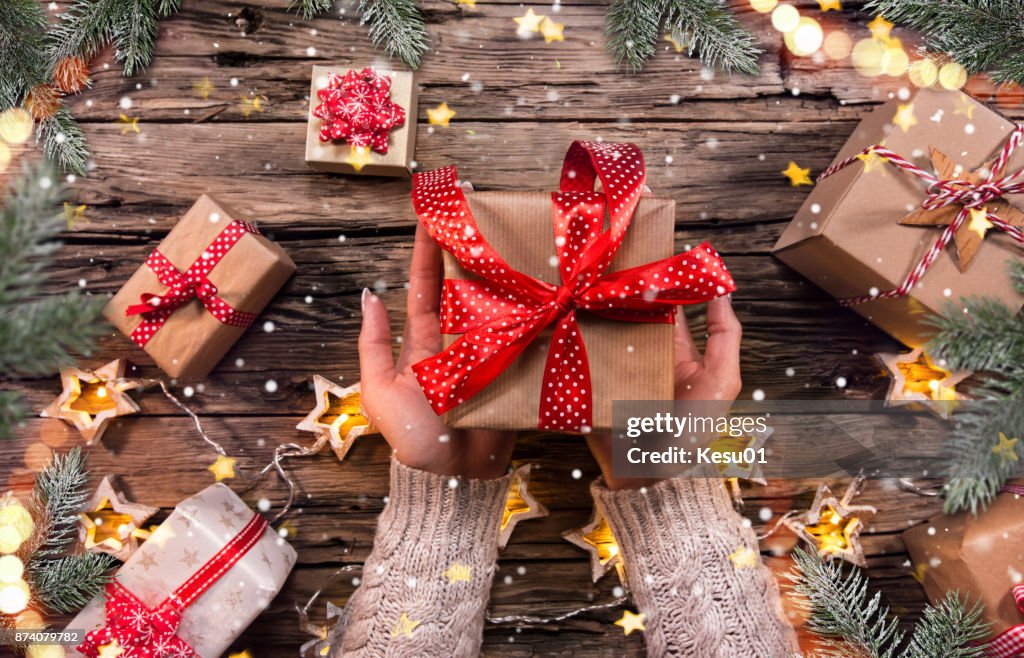 Top view of woman hands with gift box