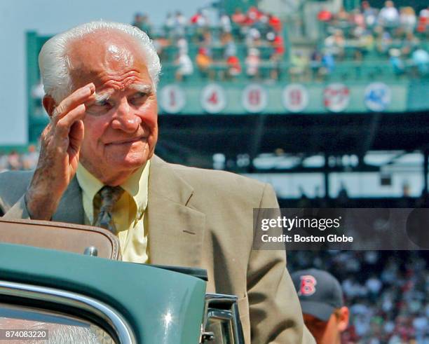 An emotional Bobby Doerr, Hall of Fame Boston Red Sox second baseman, waves to cheering fans as he rides off the field following a pre-game ceremony...