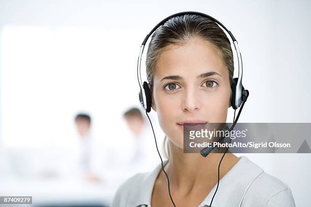 woman wearing headset, looking at camera, portrait - camera operator stock pictures, royalty-free photos & images