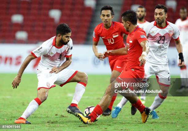 Sayed Dhiya Shubbar of Bahrain dribbles Muhammad Zulfahmi Bin Mohd Arifin of Singapore during the 2019 Asian Cup Qualifier match between Singapore...