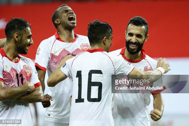 Mahdi Abdul Jabbar of Bahrain celebrates with teammates after scoring the third goal during the 2019 Asian Cup Qualifier match between Singapore and...