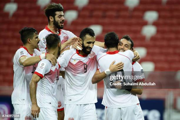 Jamal Rashed of Bahrain celebrates with teammates after scoring the second goal during the 2019 Asian Cup Qualifier match between Singapore and...
