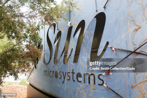 Former sign for the legacy Silicon Valley software company Sun Microsystems is visible on the back side of the main sign for social network Facebook,...