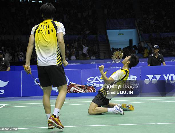 China's Cai Yun and his teammate Fu Haifeng celebrate after winning over Malaysia's Koo Kean Keat and Tan Boon Heong during the men's doubles...