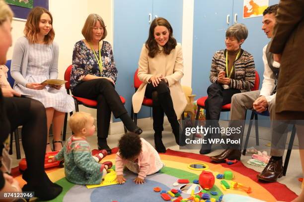 Catherine, Duchess of Cambridge watches children play in the nursery with mothers and staff as she visits the Hornsey Road Children's Centre on...