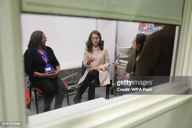 Catherine, Duchess of Cambridge talks to antenatal staff in a private office at childrens centre as she visits the Hornsey Road Children's Centre on...