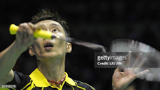 Malaysia's Lee Chong Wei returns a shuttlecock to China's Lin Dan during the men's singles semifinal match at the Sudirman Cup world badminton...
