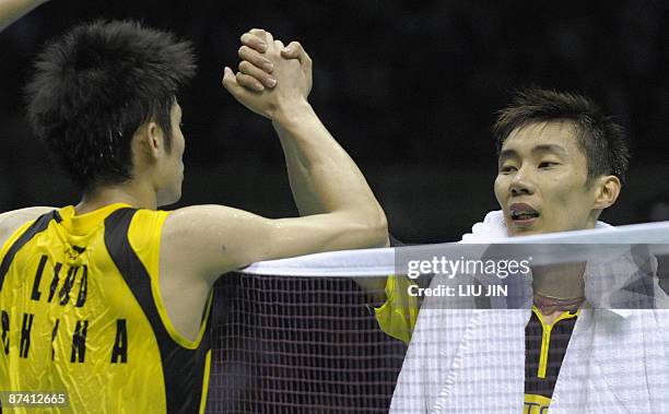 China's Lin Dan shakes hands with Malaysia's Lee Chong Wei after the men's singles semifinal match at the Sudirman Cup world badminton championships...