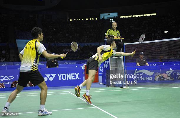 China's Fu Haifeng and his teammate Cai Yun compete against Malaysia's Koo Kean Keat and Tan Boon Heong during the men's doubles semifinal match at...