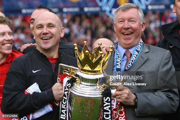 Manchester United Manager Sir Alex Ferguson and Assistant Mike Phelan celebrate with the Barclays Premier League trophy after their side won the...