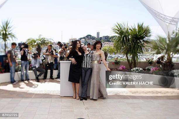 Photo taken with a tilt and shift lens shows French actress Sophie Marceau , Italian actress Monica Bellucci and French director Marina De Van posing...