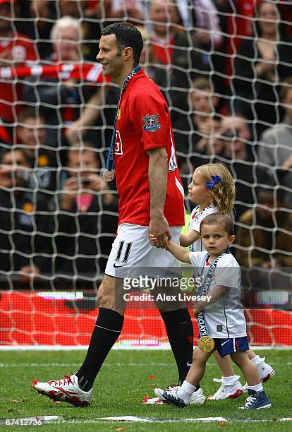 Ryan Giggs of Manchester United performs a lap of honour with his children Liberty and Zach after his side clinched the Premier League title at the...