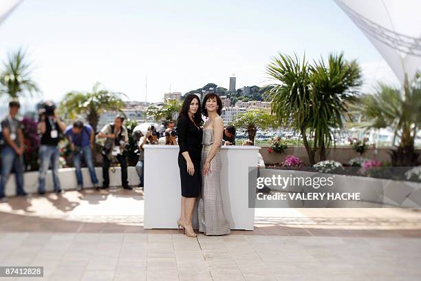 Photo taken with a tilt and shift lens shows French actress Sophie Marceau and Italian actress Monica Bellucci posing during the photocall of the...