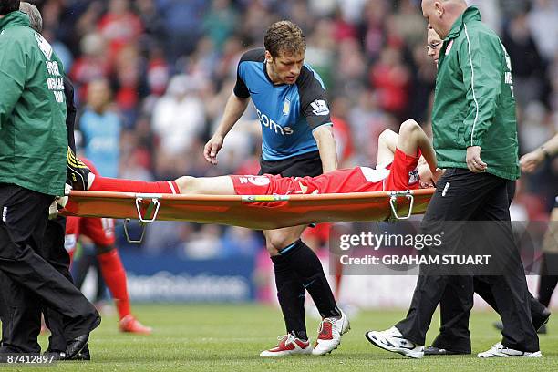 Middlesbrough's English midfielder Stewart Downing is stretchered off after a tackle by Aston Villa's Bulgarian midfielder Stiliyan Petrov during the...