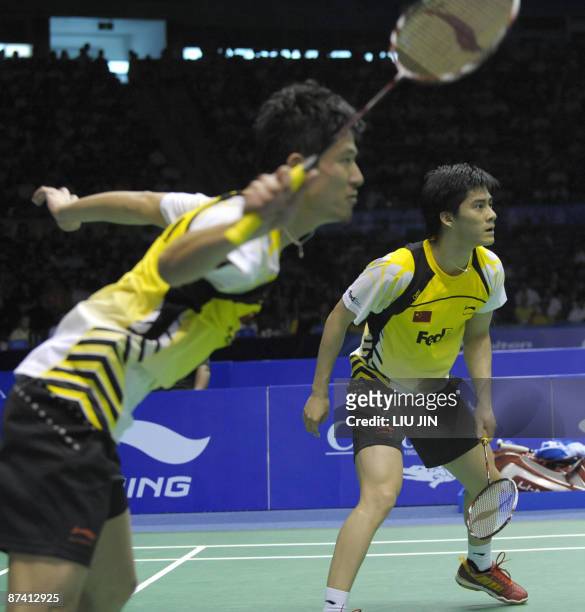 China's Fu Haifeng and his teammate Cai Yun compete during the men's doubles semifinal match against Malaysia's Koo Kean Keat and Tan Boon Heong at...
