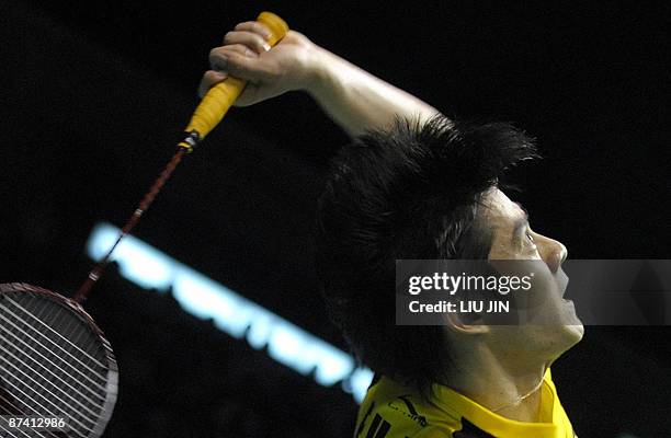 China's Fu Haifeng prepares to smash a shuttlecock during the men's doubles semifinal match against Malaysia's Koo Kean Keat and Tan Boon Heong at...