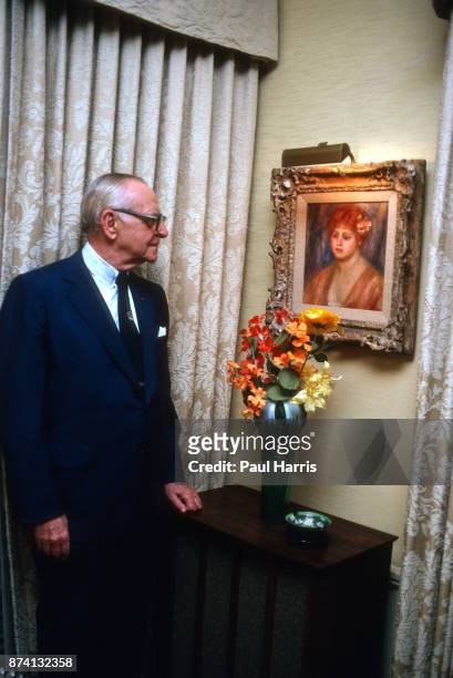 Dr Armand Hammer was an American business manager and owner, most closely associated with Occidental Petroleum, photographed at home looking at one...